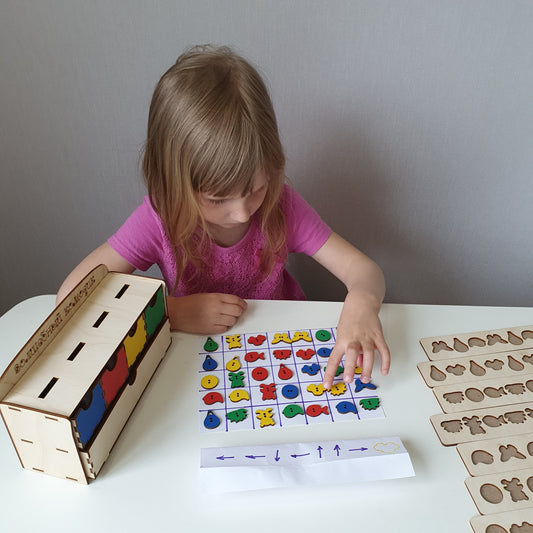A child using a wooden color sorting chest of drawers, a tactile sensory toy for autism and ADHD