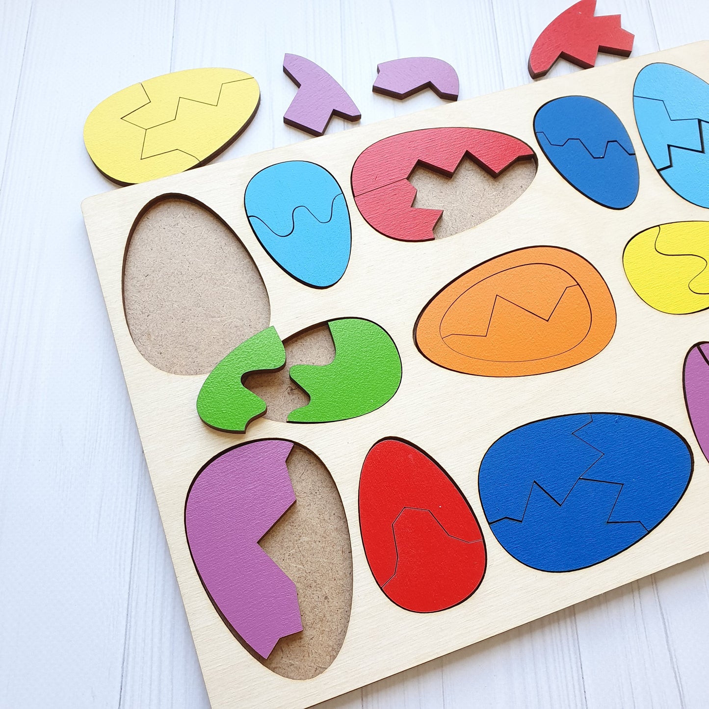 The same wooden egg pieces from another angle, with the two egg sizes visible side by side